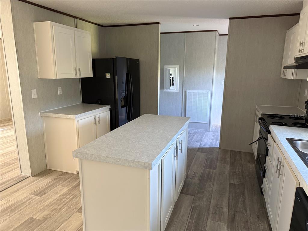 1561 Poe Road Lake Wales, FL 33898 - Photo 5 of 15 a kitchen with a refrigerator and a stove