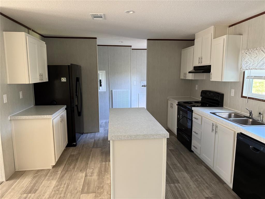 1561 Poe Road Lake Wales, FL 33898 - Photo 6 of 15 a kitchen with a sink a stove and refrigerator