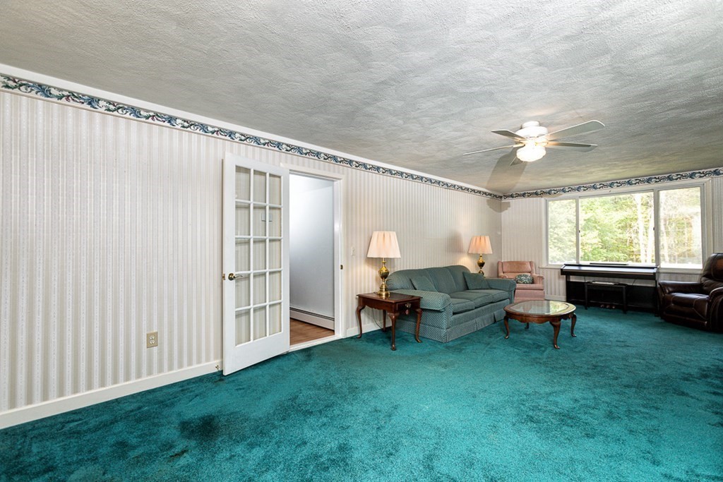 113 Newbury Road Rowley, MA 01969 - Photo 12 of 26 a living room with furniture and a large window