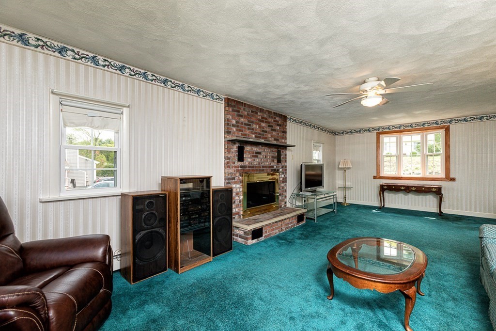113 Newbury Road Rowley, MA 01969 - Photo 13 of 26 a living room with furniture a window and a flat screen tv