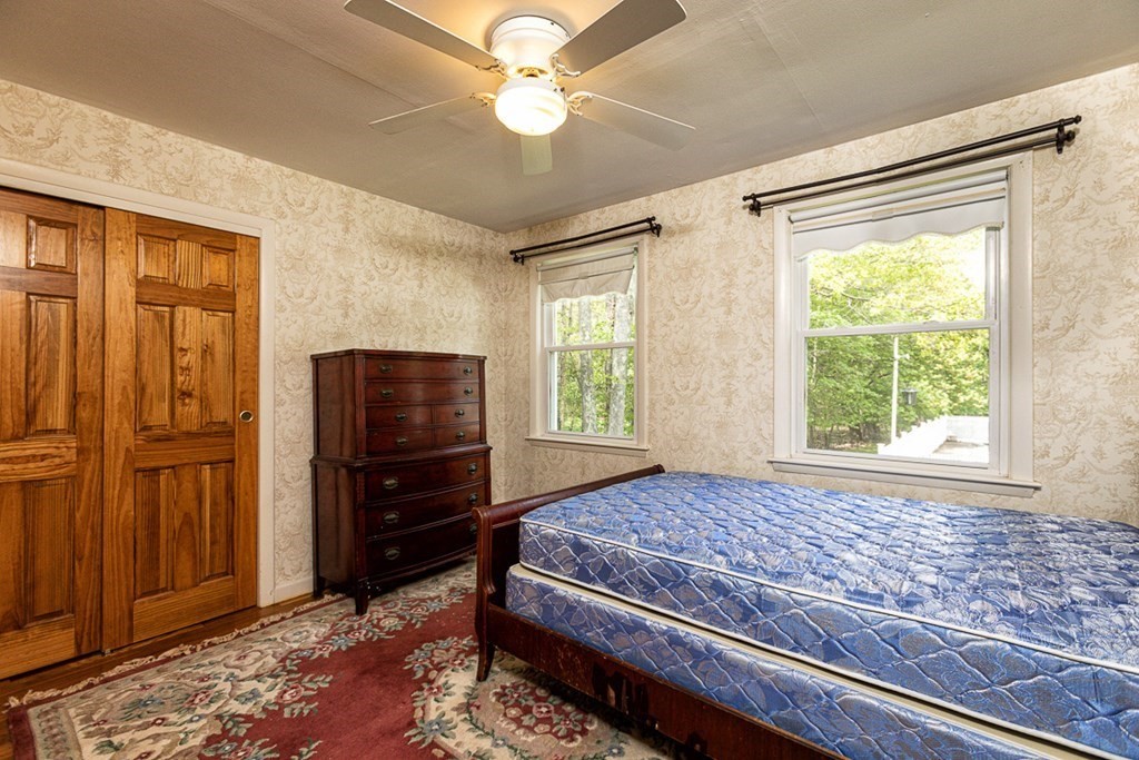 113 Newbury Road Rowley, MA 01969 - Photo 15 of 26 a bedroom with a bed and a window