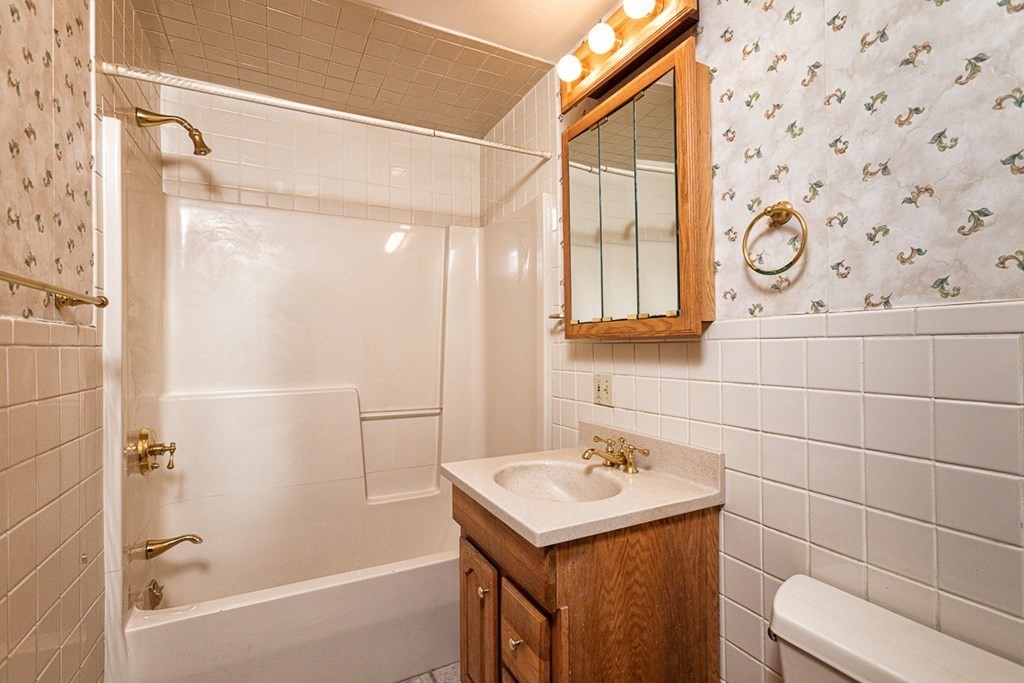 113 Newbury Road Rowley, MA 01969 - Photo 17 of 26 a bathroom with a sink a toilet and shower