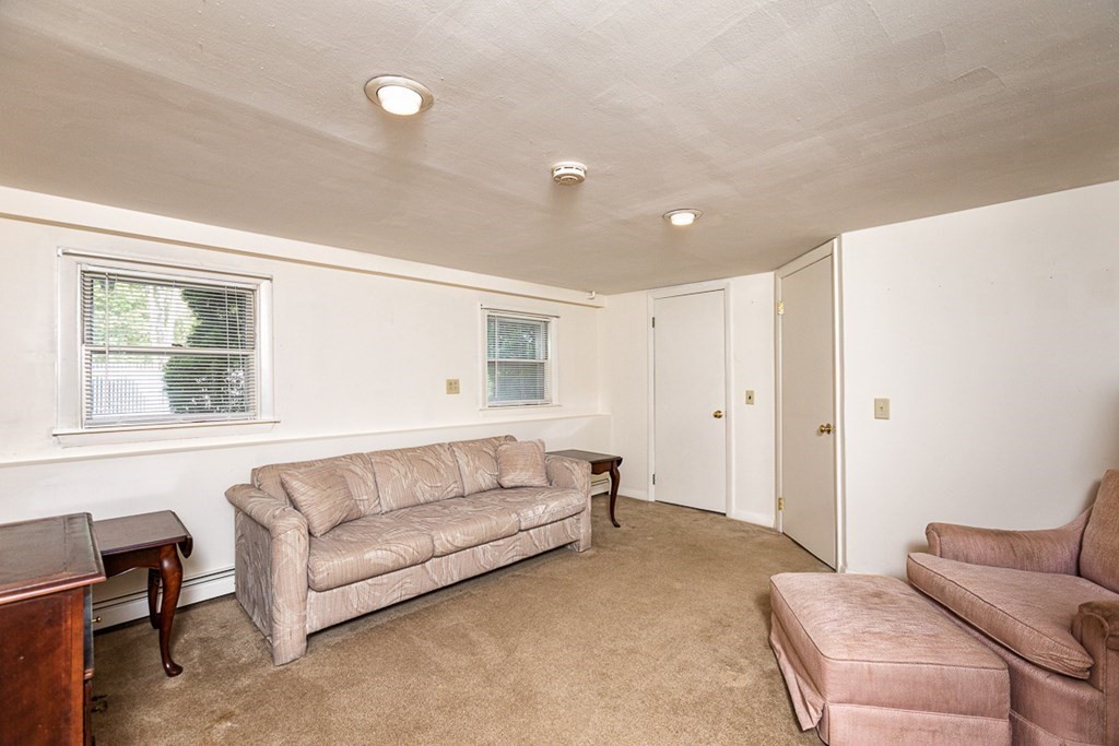 113 Newbury Road Rowley, MA 01969 - Photo 19 of 26 a living room with furniture and a window