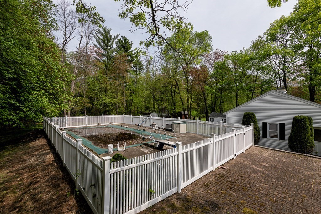 113 Newbury Road Rowley, MA 01969 - Photo 5 of 26 a view of a wooden deck and a forest