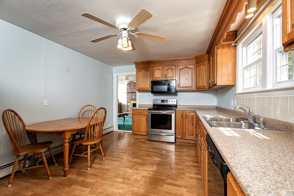 113 Newbury Road Rowley, MA 01969 - Photo 7 of 26 a kitchen with granite countertop a sink appliances and cabinets