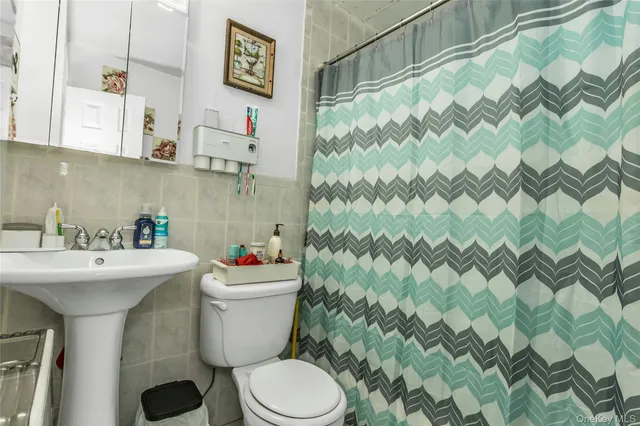 a bathroom with a sink toilet and a shower