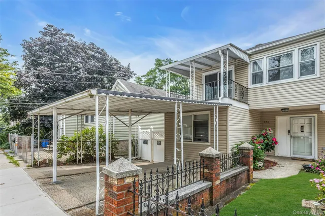 a front view of house with yard and outdoor seating