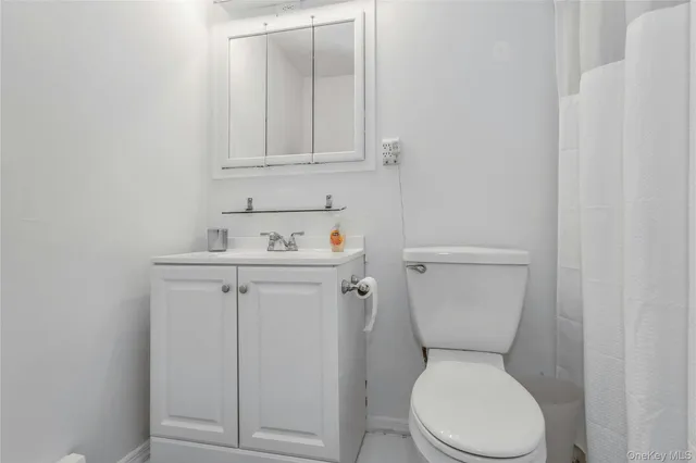 a white toilet sitting next to a bathroom sink