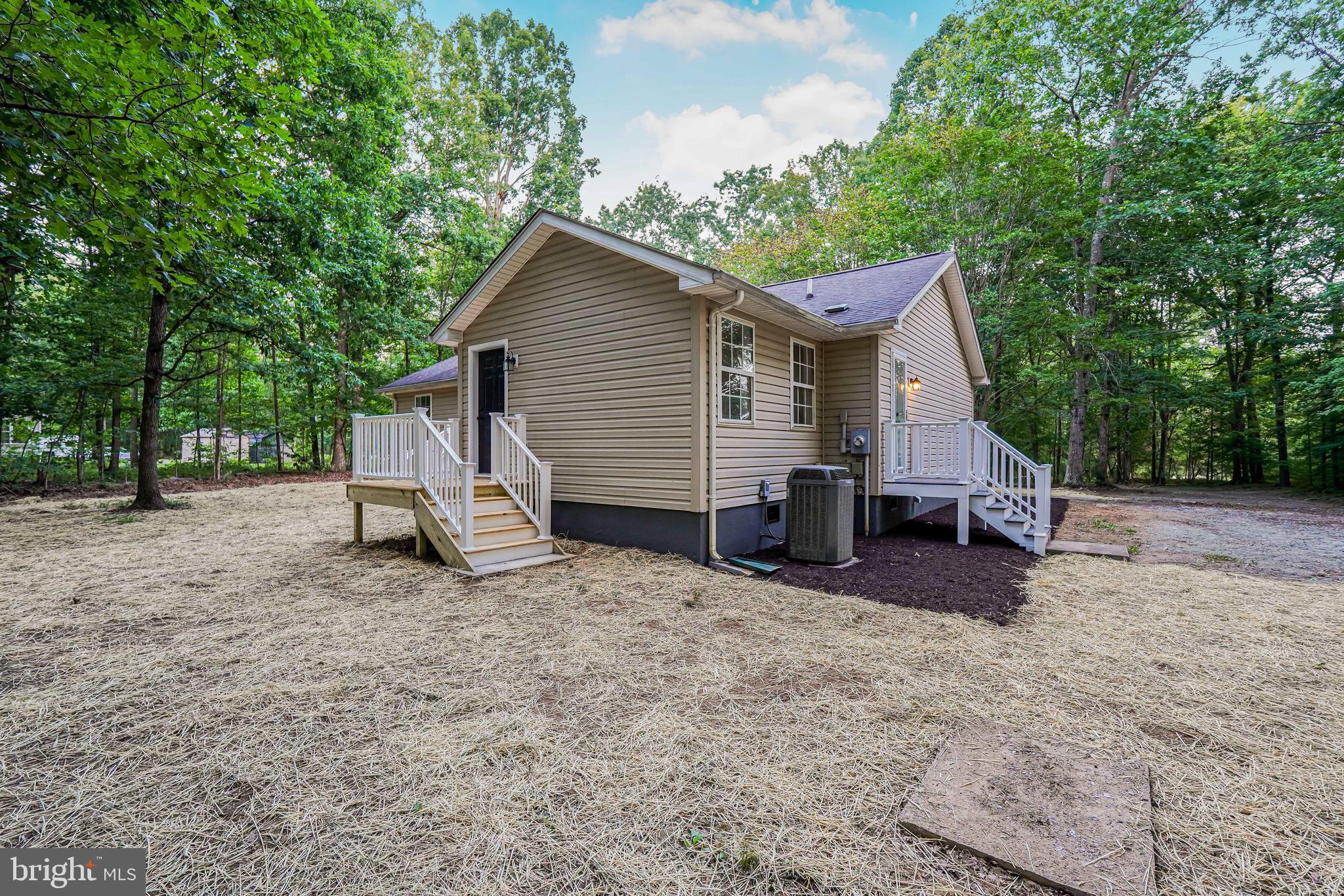 767 Loving Road Zion Crossroads, VA 22942 - Photo 27 of 33 a view of a house with a yard and trees in the background