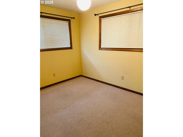 a view of a small space with wooden floor and a window