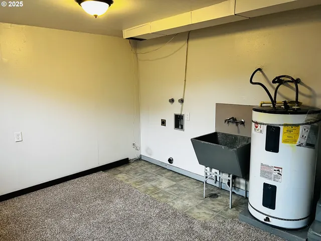 a room with table chairs and a painting on the wall