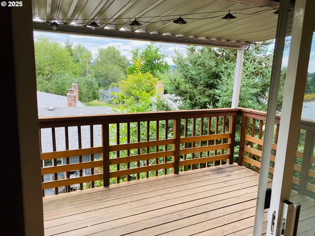 a view of a balcony with wooden floor