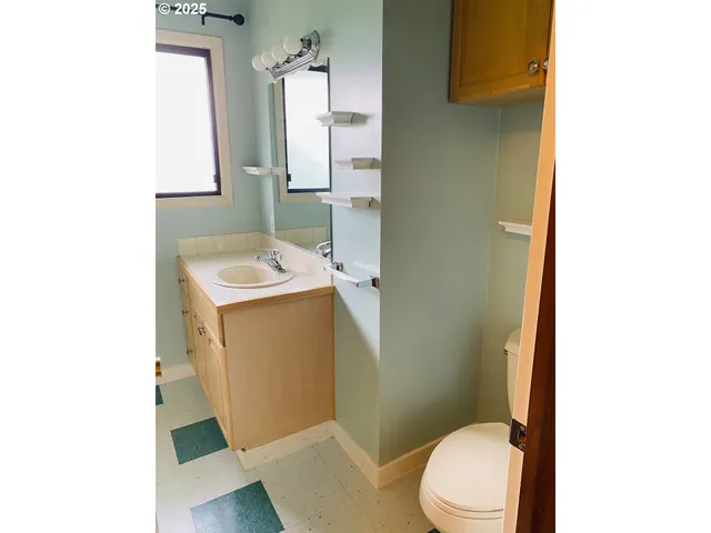 a bathroom with a sink toilet and mirror