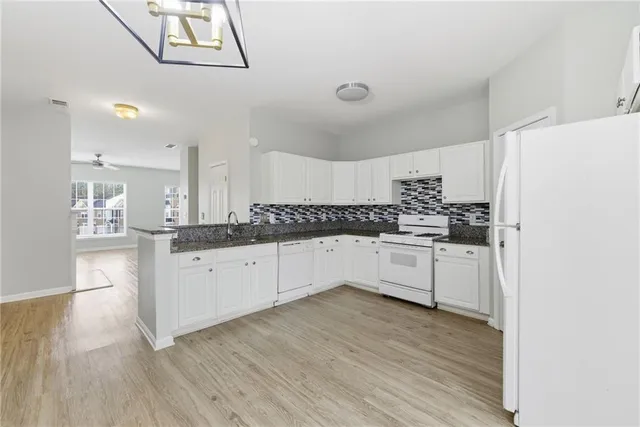 a view of balcony with wooden floor and fence