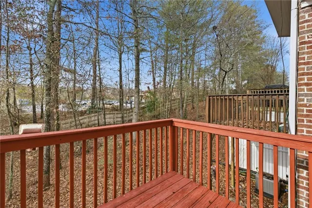 a view of a livingroom with wooden floor and staircase