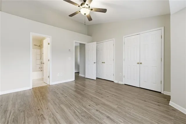 a bathroom with a granite countertop sink a toilet and bathtub