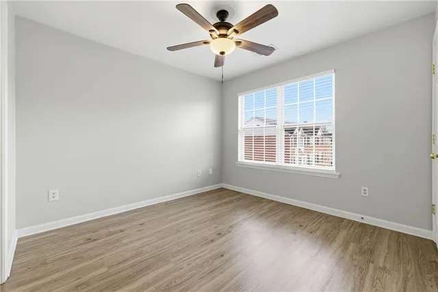 a view of an empty room and wooden floor
