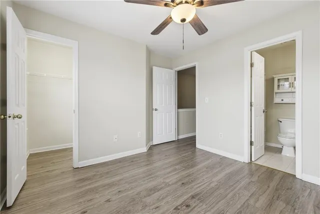 a bathroom with a granite countertop sink a toilet and a mirror
