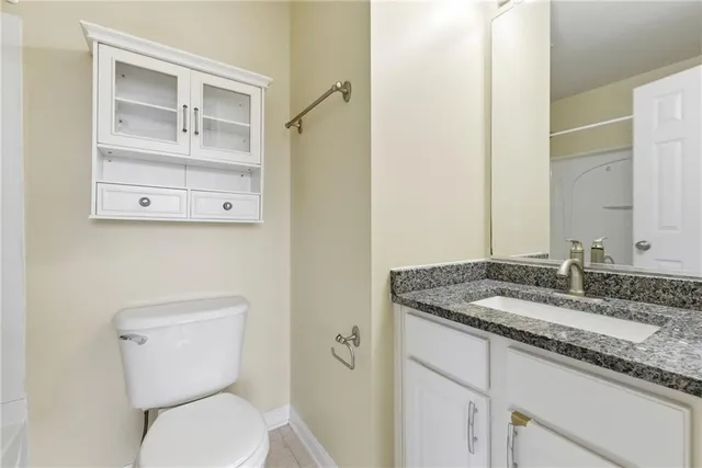 a bathroom with a bathtub shower and toilet