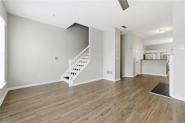 a view of wooden floor and windows in a room