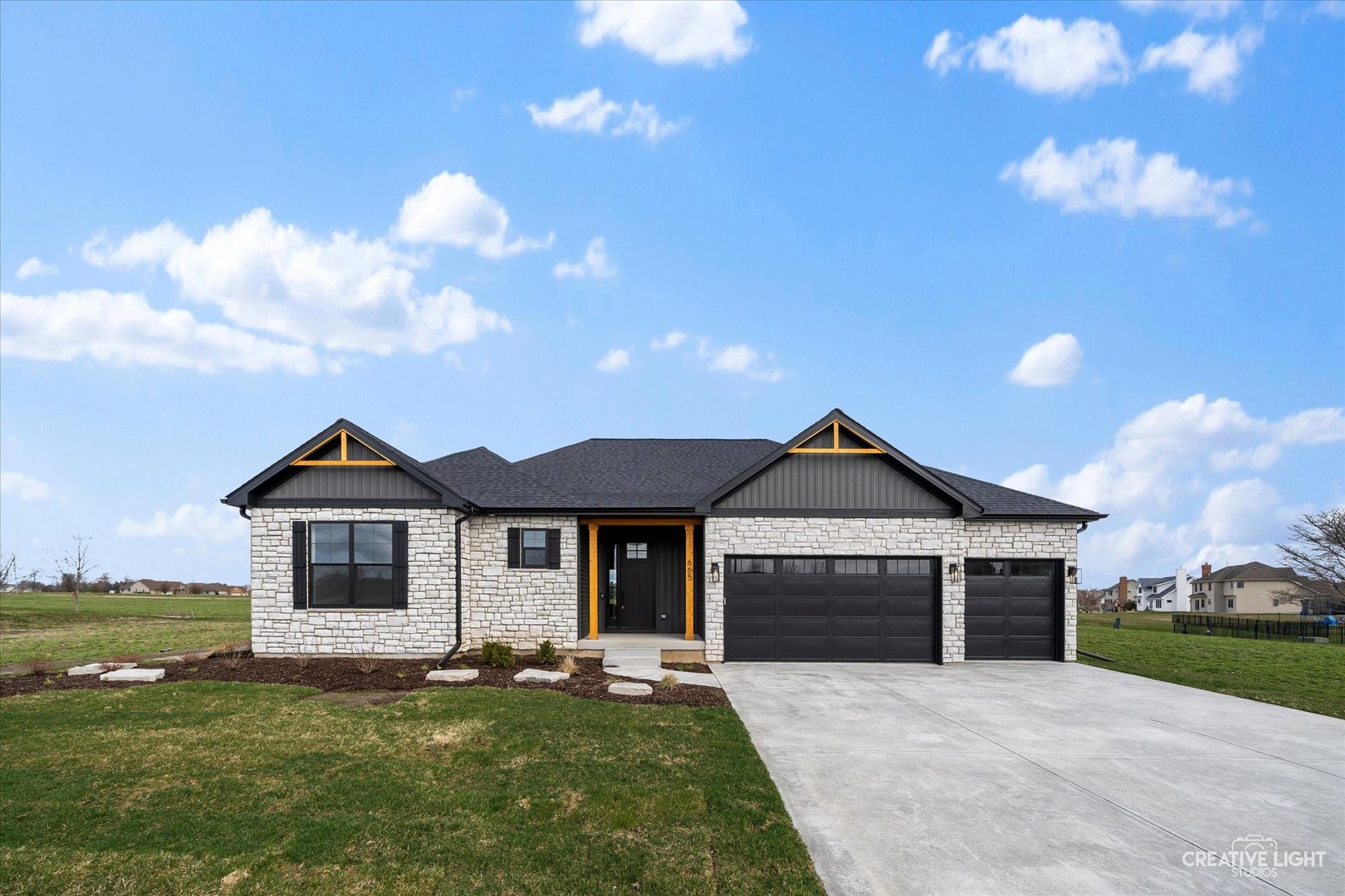 a front view of a house with a garden and yard