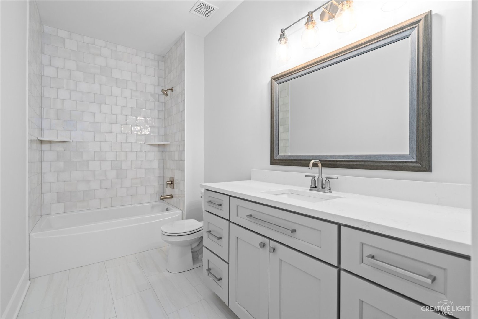 665 Ivan Drive Sycamore, IL 60178 - Photo 21 of 30 a bathroom with a granite countertop sink a toilet and a mirror