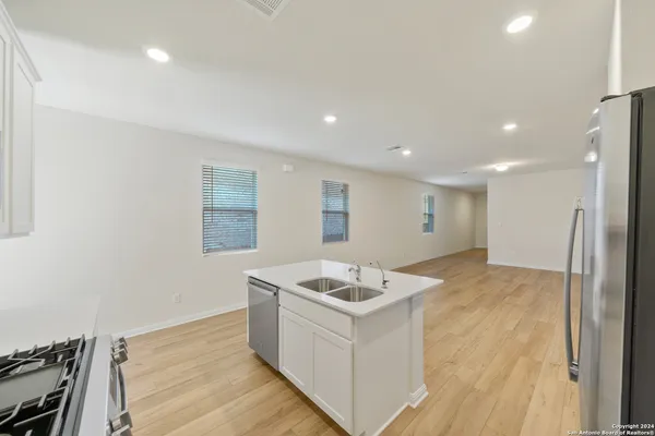 a kitchen with a sink stove and refrigerator