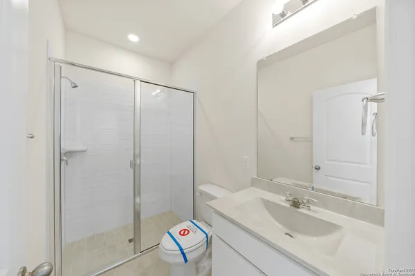 a bathroom with a sink toilet and shower