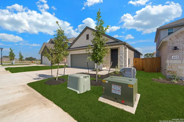 a view of a house with backyard sitting area and garden