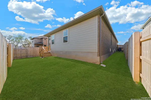 a view of a backyard with potted plants