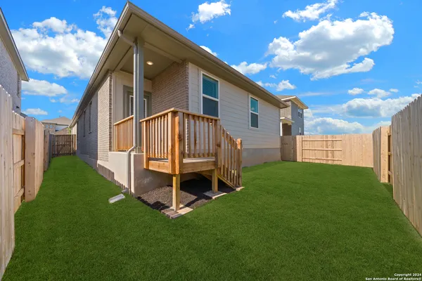 a view of backyard with a garden and deck