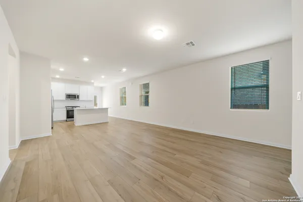 a view of kitchen with wooden floor and windows