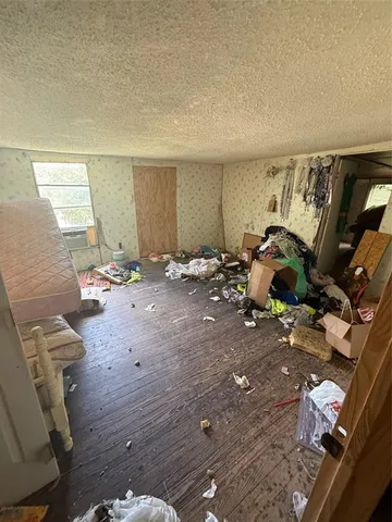 a bedroom with furniture and a wooden floor