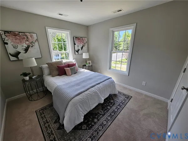 a bedroom with a bed a mirror and furniture