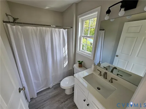 a bathroom with a sink toilet and tub