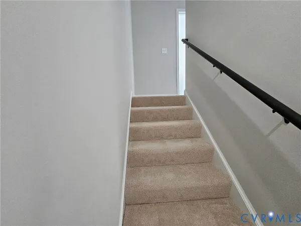 a view of staircase with white walls