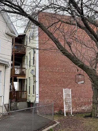 a brick building with a tree in front of it
