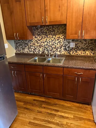 a view of room with wooden cabinets