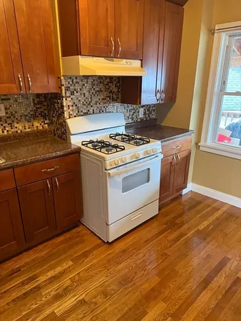 a kitchen with granite countertop a stove and a sink