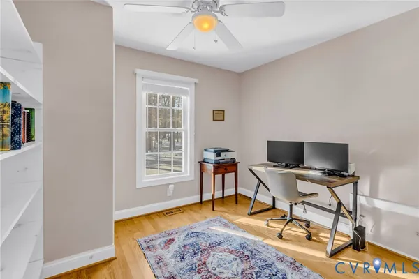 a view of a workspace with furniture and a window