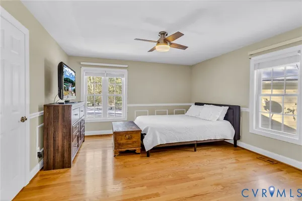 a spacious bedroom with a bed and window