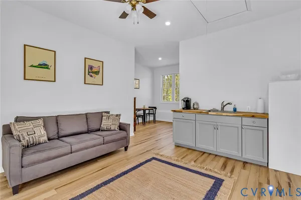 a living room with furniture and a wooden floor