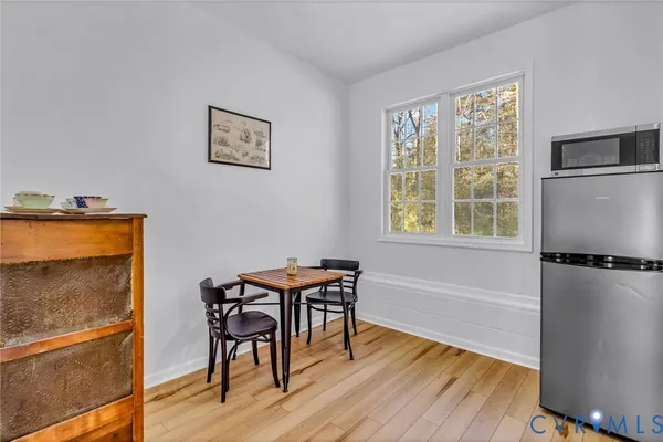 a view of a dining room with furniture window and wooden floor