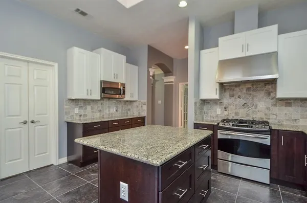 a kitchen with a stove microwave and refrigerator