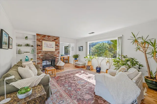 a living room with furniture and a potted plant