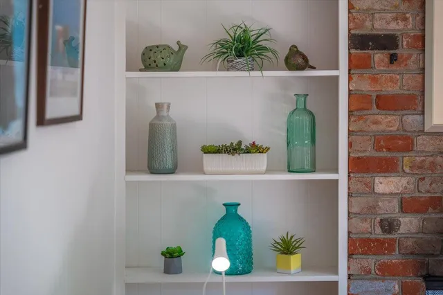 a living room with a bed furniture and a large window