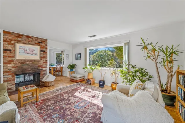 a living room with furniture a rug and a fireplace