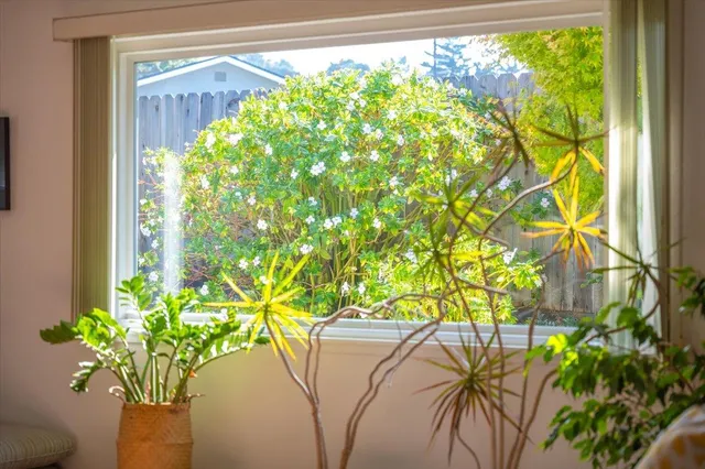a living room with fireplace furniture and a rug