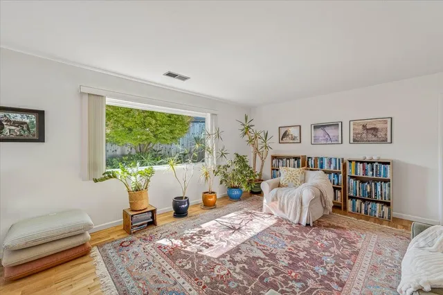 a living room with furniture a fireplace and a table