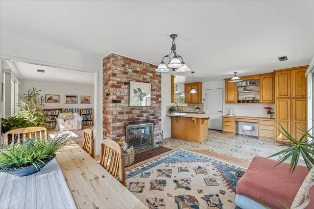 a view of a hallway with wooden floor and chandelier